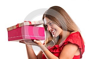 Young pretty girl in red dress holding presents. isolated