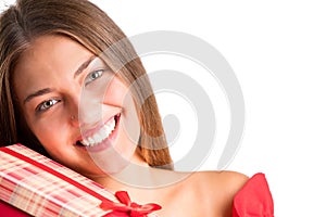 Young pretty girl in red dress holding presents. isolated