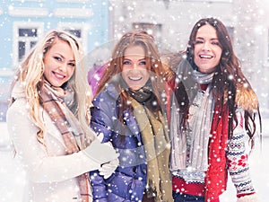 Young and pretty girl skating on outdoor open air ice-rink at wi