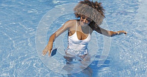 Woman dropping phone in pool
