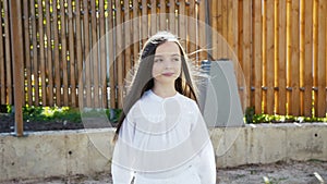 Young pretty girl walks with poses on the manege at camera