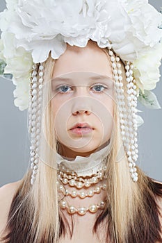 Young pretty girl in white spring flower wreath, close up beauty portrait