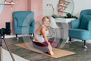 Young pretty happy woman doing yoga pose for stretching and flexibility.