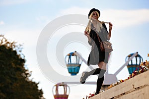 Young pretty hipster girl outdoor in sunny day, wearing casual clothiers hat