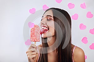 Young pretty indian girl on background with pink hearts. Stylish young woman with ice cream