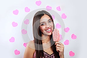 Young pretty indian girl on background with pink hearts. Stylish young woman with ice cream