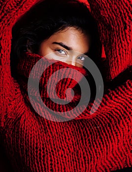 Young pretty indian mulatto girl in red sweater posing emotional, fashion hipster teenage, lifestyle people concept