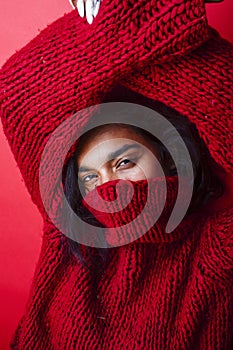 Young pretty indian mulatto girl in red sweater posing emotional