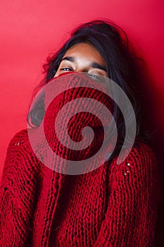 Young pretty indian mulatto girl in red sweater posing emotional