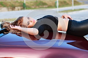 Young pretty lady with a clasic car