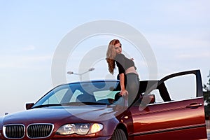 Young pretty lady with a clasic car