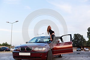 Young pretty lady with a clasic car photo