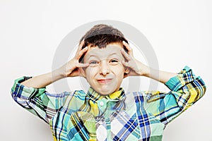 Young pretty little boy kid wondering, posing emotional face isolated on white background, gesture happy smiling close