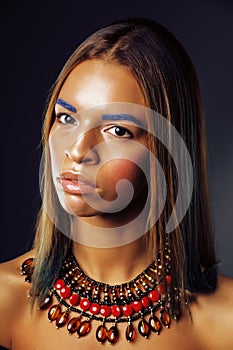 Young pretty modern african american girl with bright fashion make up and ethnical jewelry, lifestyle people concept