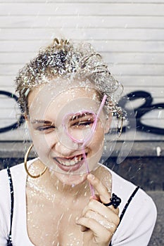 Young pretty party girl smiling covered with glitter tinsel, fashion dress, stylish make up, lifestyle people concept