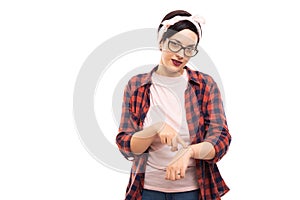 Young pretty pin-up girl wearing glasses showing late gesture