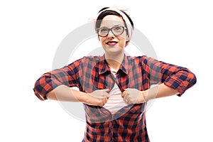 Young pretty pin-up girl wearing glasses unbuttoning shirt