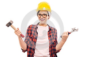 Young pretty pin-up girl with yellow helmet holding tools