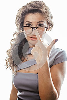 Young pretty real brunette woman secretary in dress wearing glasses isolated on white background pointing gesturing