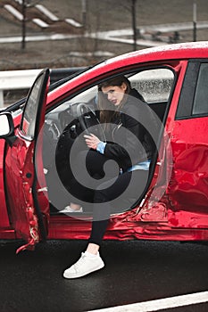 Young pretty scared woman in the car. Injured woman feeling bad after having a car crash.