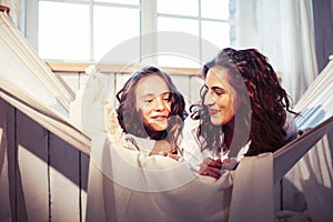 Young pretty sisters at home early morning in hammock, lifestyle casual people concept