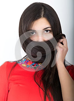 Young pretty slim asian woman standing in a little red dress, She covers her face with her hair