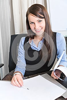 Young pretty smiling business woman