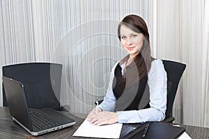 Young pretty smiling business woman