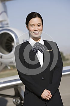 Young Pretty Stewardess Standing At Airfield photo