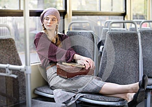 Young pretty student girl in city tram