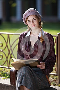 Young pretty student girl reading a book