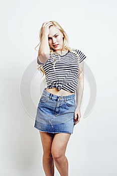Young pretty stylish blond hipster girl posing emotional isolate