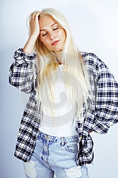 Young pretty stylish blond hipster girl posing emotional isolate