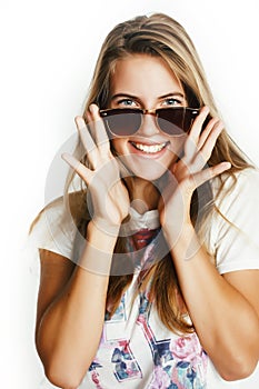 Young pretty teen blond girl posing cheerful isolated on white background wearing sunglasses, lifestyle people concept