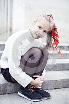 Young pretty teenage blond girl happy smiling outside, lifestyle people concept