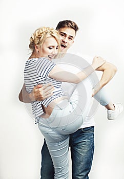 Young pretty teenage couple, hipster guy with his girlfriend happy smiling and hugging isolated on white background