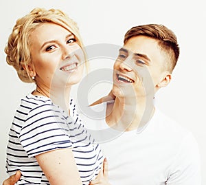 Young pretty teenage couple, hipster guy with his girlfriend happy smiling and hugging on white background