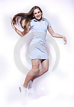 young pretty teenage girl jumping cheerful isolated on white background, lifestyle people concept