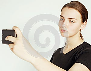 Young pretty teenage girl making selfie isolated on white background close up