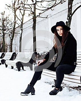 Young pretty teenage hipster girl outdoor in winter snow park ha