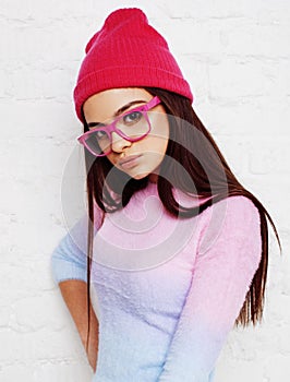 Young pretty teenage hipster girl posing emotional happy smiling on white background, lifestyle people concept