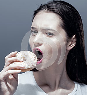 Young pretty thin girl with donut close up