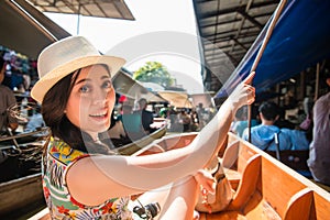 Young pretty travel woman sitting on river boat