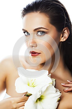 Young pretty woman with Amarilis flower close up isolated on white, hands manicure, spa people concept