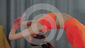 Young pretty woman bending backwards on yoga mat