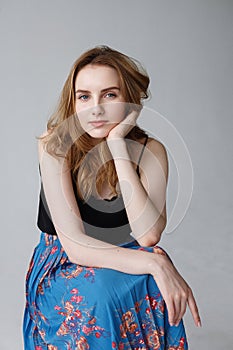 young pretty woman in blue skirt, indoors portrait of cute smiling model