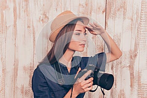 Young pretty woman with camera looking for new cadre