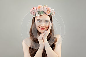 Young pretty woman with clear skin, healthy hair and flowers wreath photo