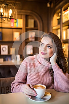 Young pretty woman drink coffee in cafe shop