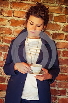 Young pretty woman drinking coffee